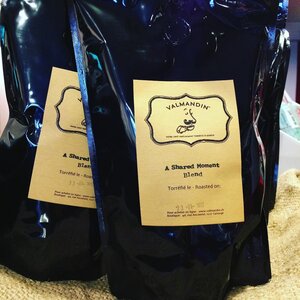 Packages of freshly roasted Valmandin's A Shared Moment Blend artisan coffee.