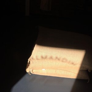 The Valmandin name being projected on to a jute bag of coffee grains that are the basis of Valmandin's delicious, freshly artisan roasted gourmet coffee.