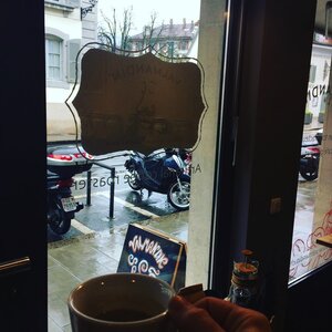 Warm your heart with a freshly roasted cup of Valmandin coffee. View of the cup onto the rainy street.
