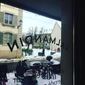 A view on snowy Carouge from the Valmandin coffee roaster shop window