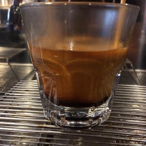 A glass of freshly brewed Valmandin espresso with very thick crema